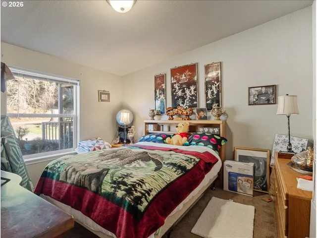 a bedroom with bed and a window