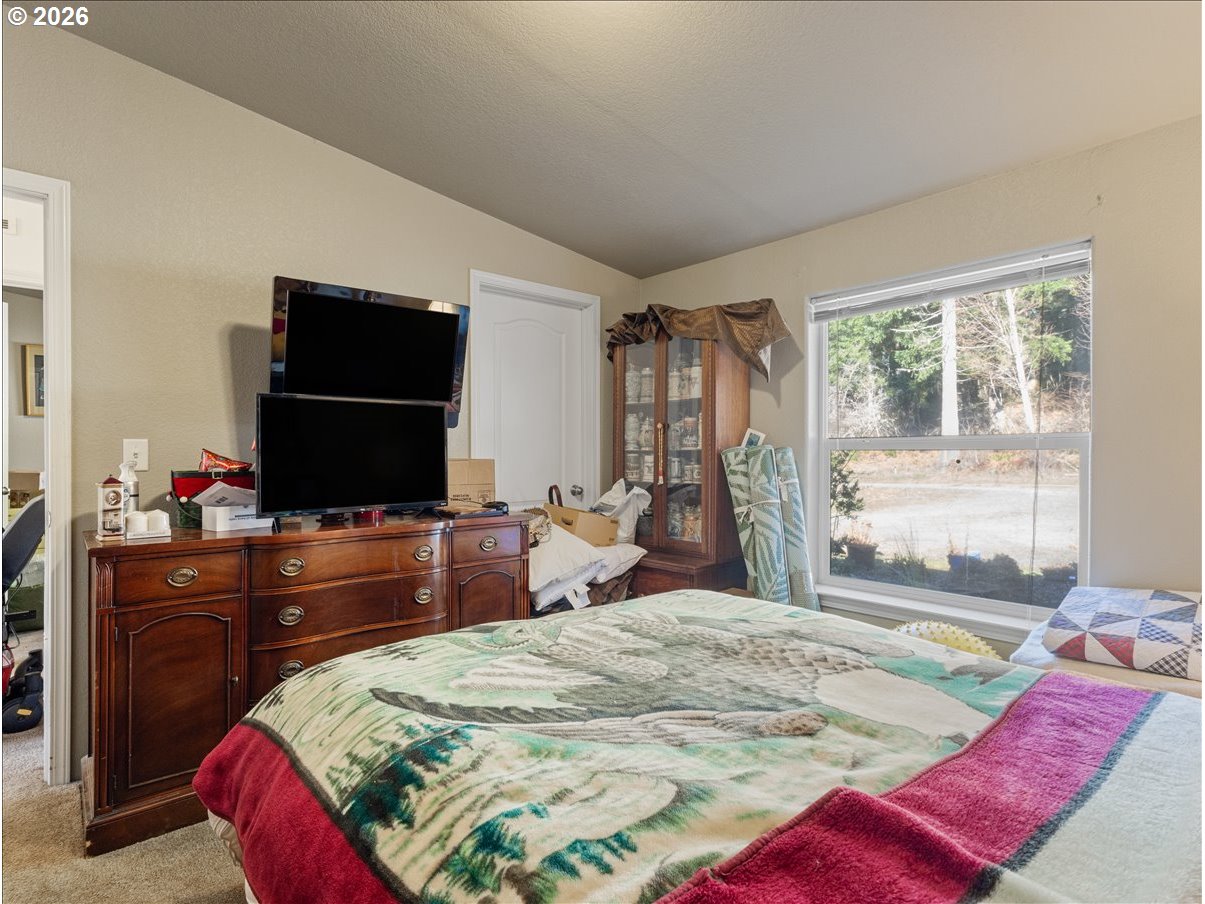 23728 Northeast Dole Valley Road Yacolt, WA 98675 - Photo 21 of 46 a bedroom with a bed and a flat screen tv