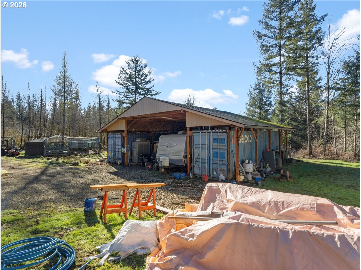 23728 Northeast Dole Valley Road Yacolt, WA 98675 - Photo 28 of 46 a view of patio with a table and chairs under an umbrella