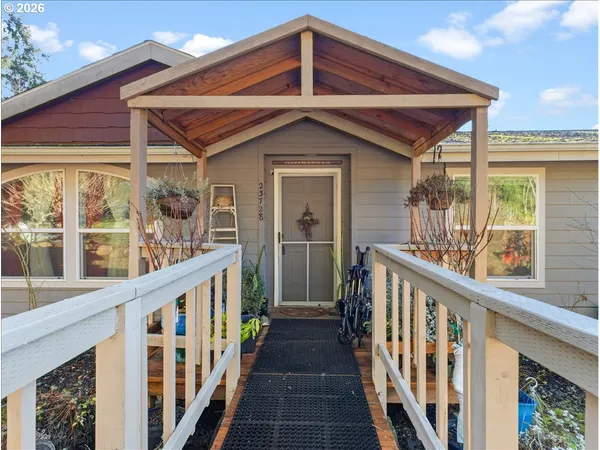 a view of a house with wooden fence