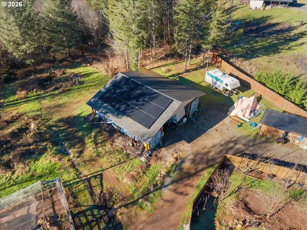 an aerial view of a house with a yard