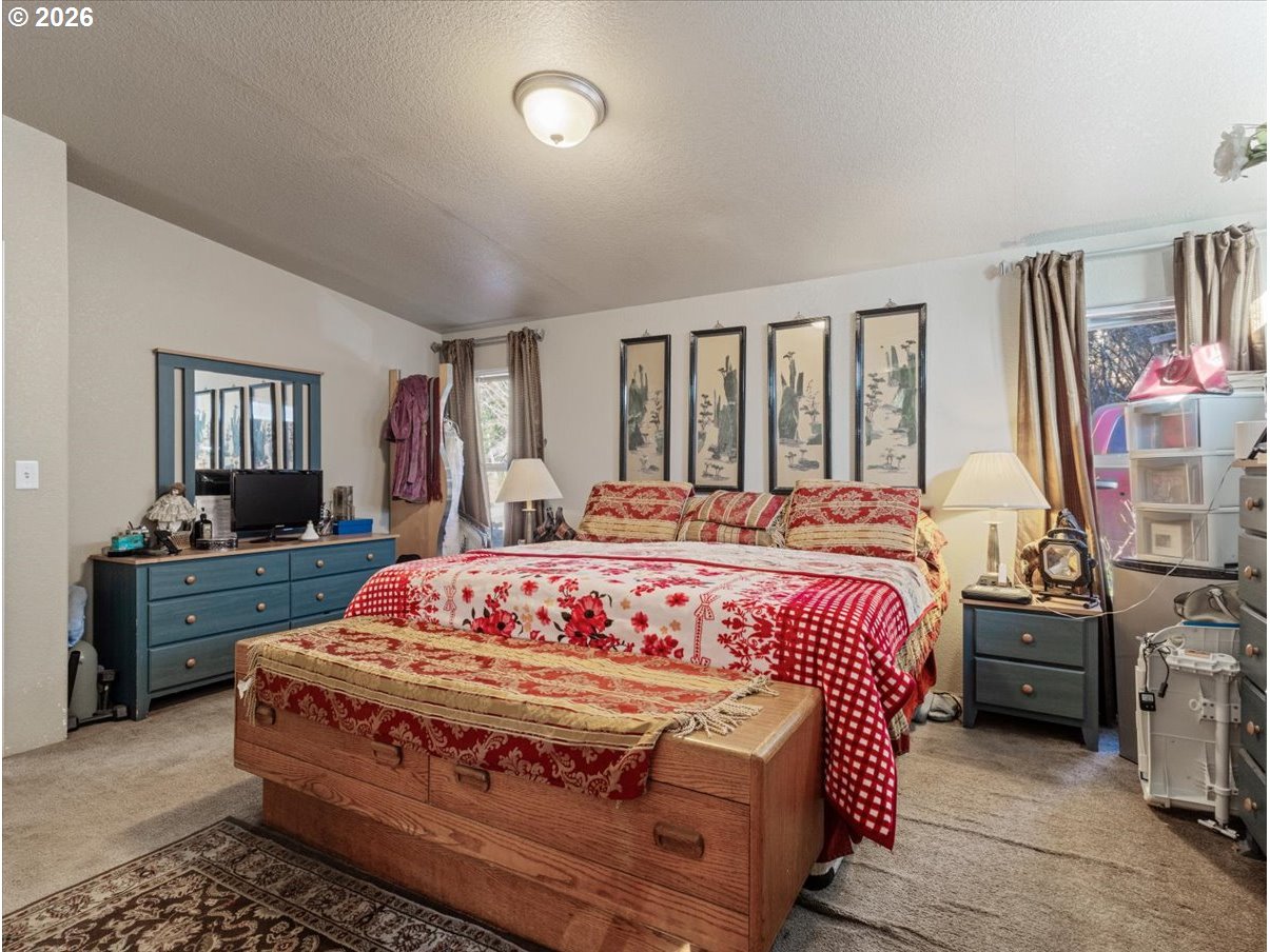 23728 Northeast Dole Valley Road Yacolt, WA 98675 - Photo 9 of 46 a bedroom with a bed and wooden floor