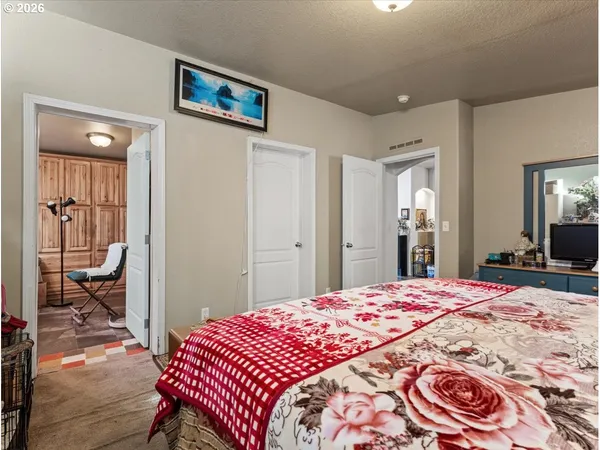 a bedroom with a bed and a lamp