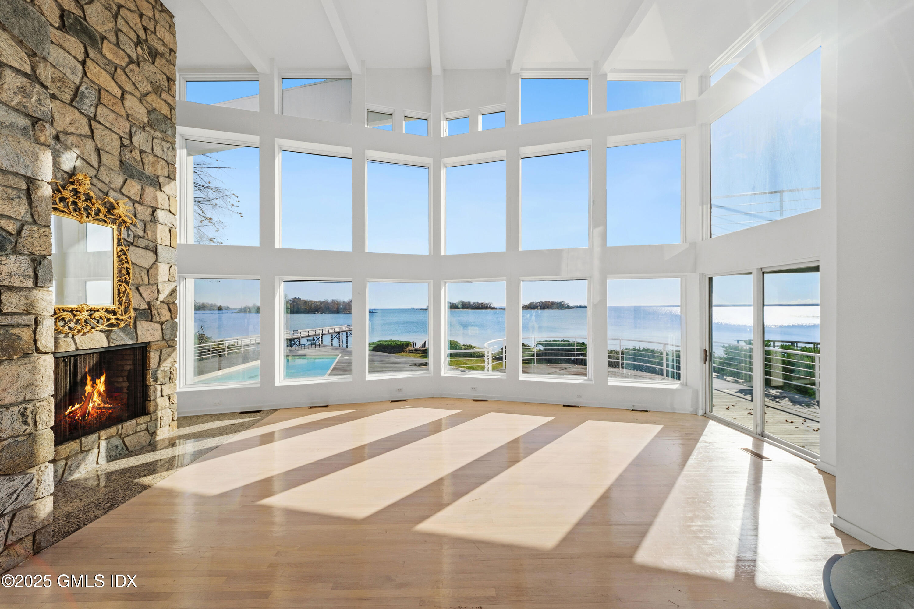 111 Byram Shore Road Greenwich, CT 06830 - Photo 7 of 23 a living room with a large window and a fireplace