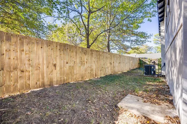 a view of small yard with wooden fence