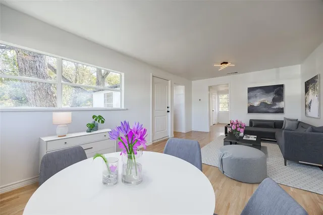 a dining room with furniture and a potted plant