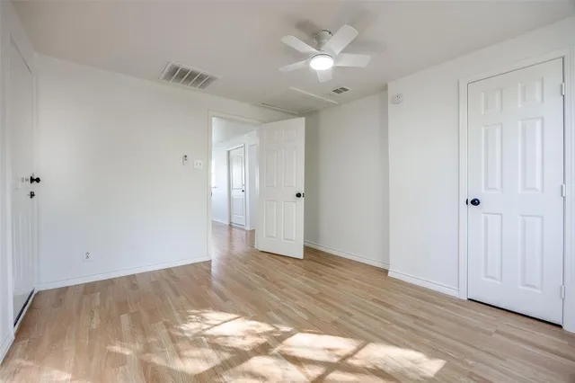 a view of an empty room and wooden floor