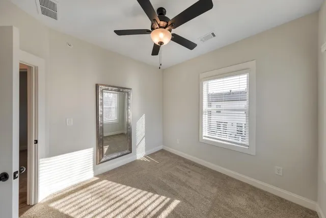 a view of a livingroom with furniture and a window