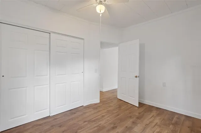 a view of an empty room with wooden floor