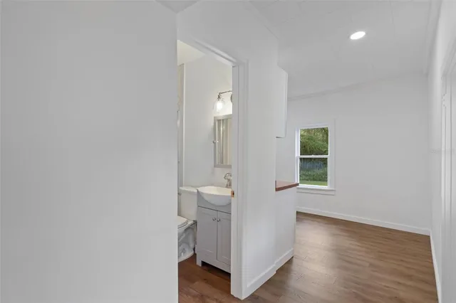 a view of a room with wooden floor and window