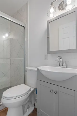 a bathroom with a sink a toilet and a mirror