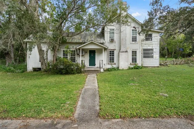 a front view of house with yard and green space