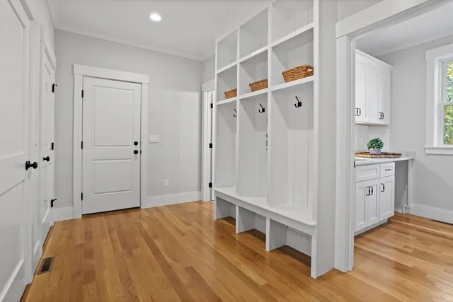 a view of empty room with wooden floor and cabinet