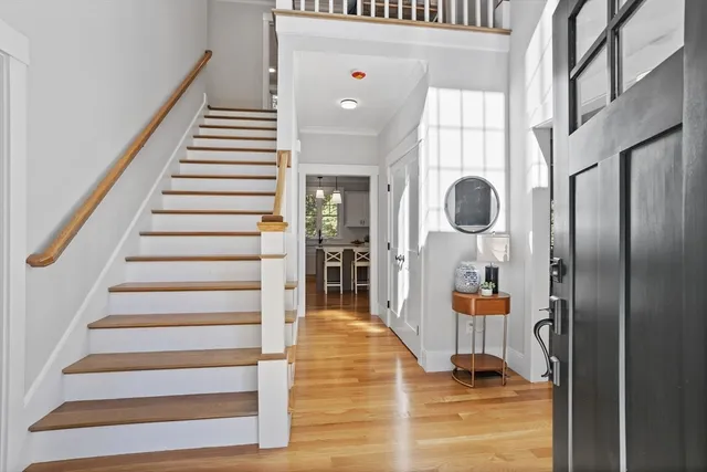 a view of entryway and hall with wooden floor