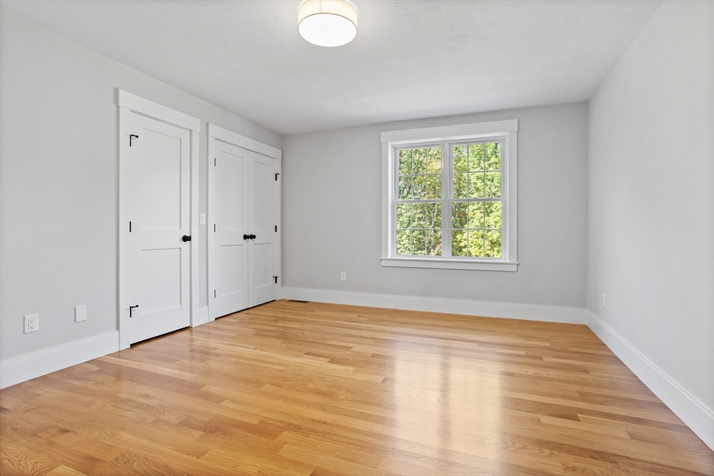236 Bolton Road Harvard, MA 01451 - Photo 19 of 42 a view of an empty room with wooden floor and a window