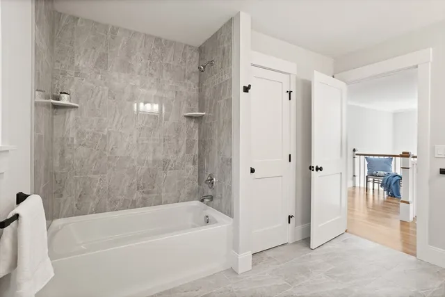 a bathroom with a bathtub and a shower