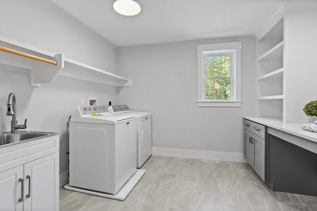 a utility room with sink dryer and washer