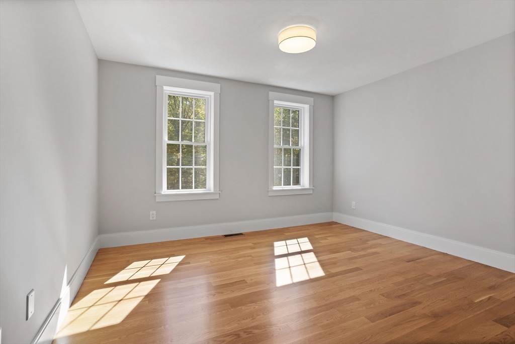 236 Bolton Road Harvard, MA 01451 - Photo 24 of 42 an empty room with wooden floor and windows