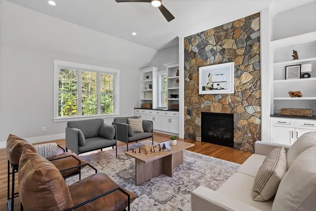 a living room with furniture a rug and a fireplace