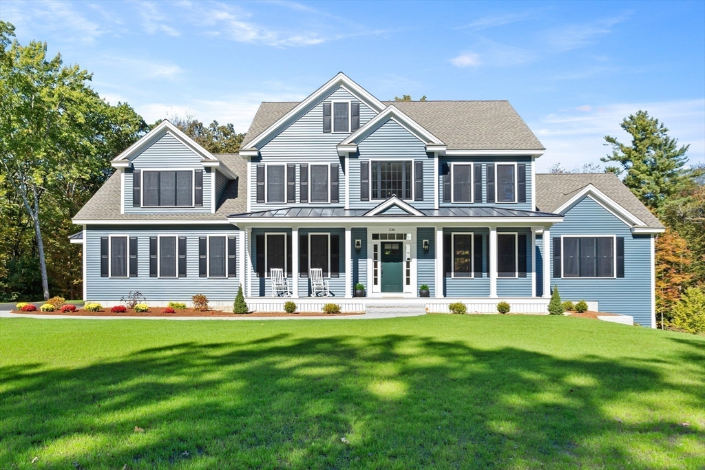236 Bolton Road Harvard, MA 01451 - Photo 42 of 42 a front view of a house with a yard with trees and seating area