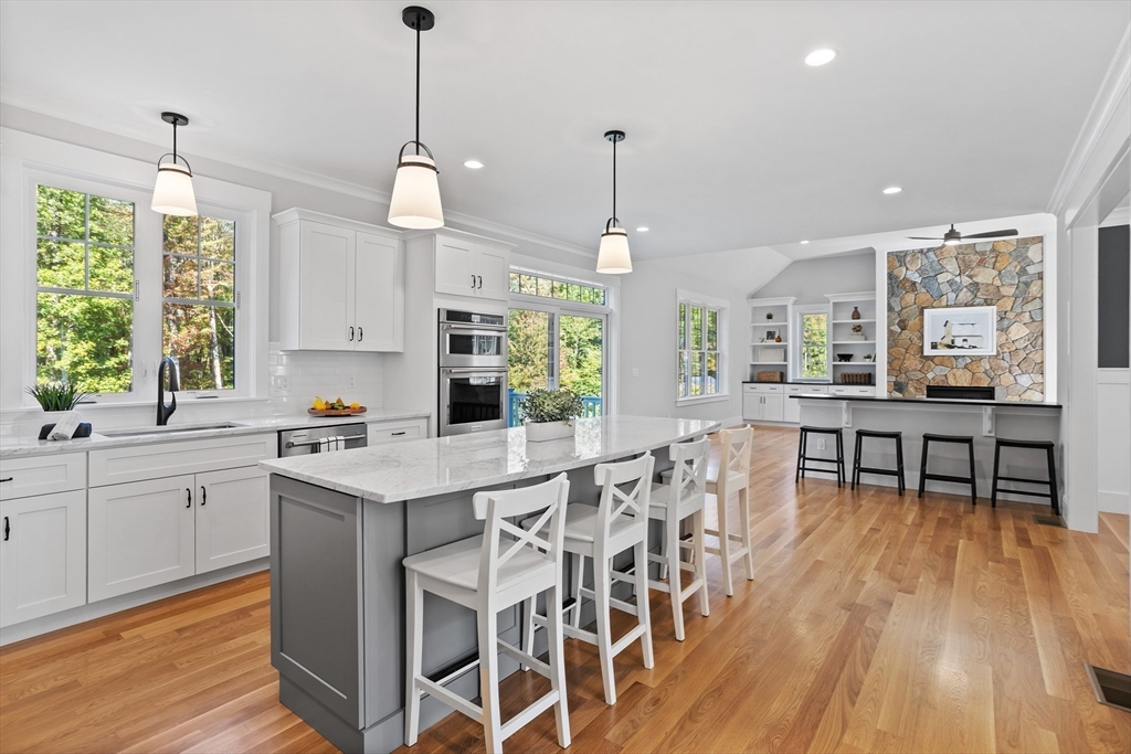 236 Bolton Road Harvard, MA 01451 - Photo 10 of 42 a kitchen with stainless steel appliances granite countertop table chairs stove and sink