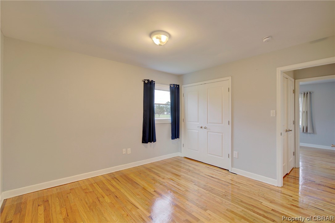 1373 Fitchetts Wharf Road Moon, VA 23119 - Photo 18 of 22 Unfurnished bedroom featuring light hardwood / wood-style flooring and a closet