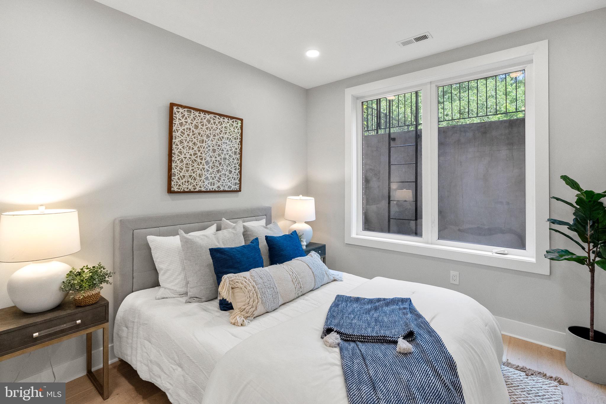 2019 M Street Northeast, Unit 1 Washington, DC 20002 - Photo 18 of 31 a bed room with a bed and a window
