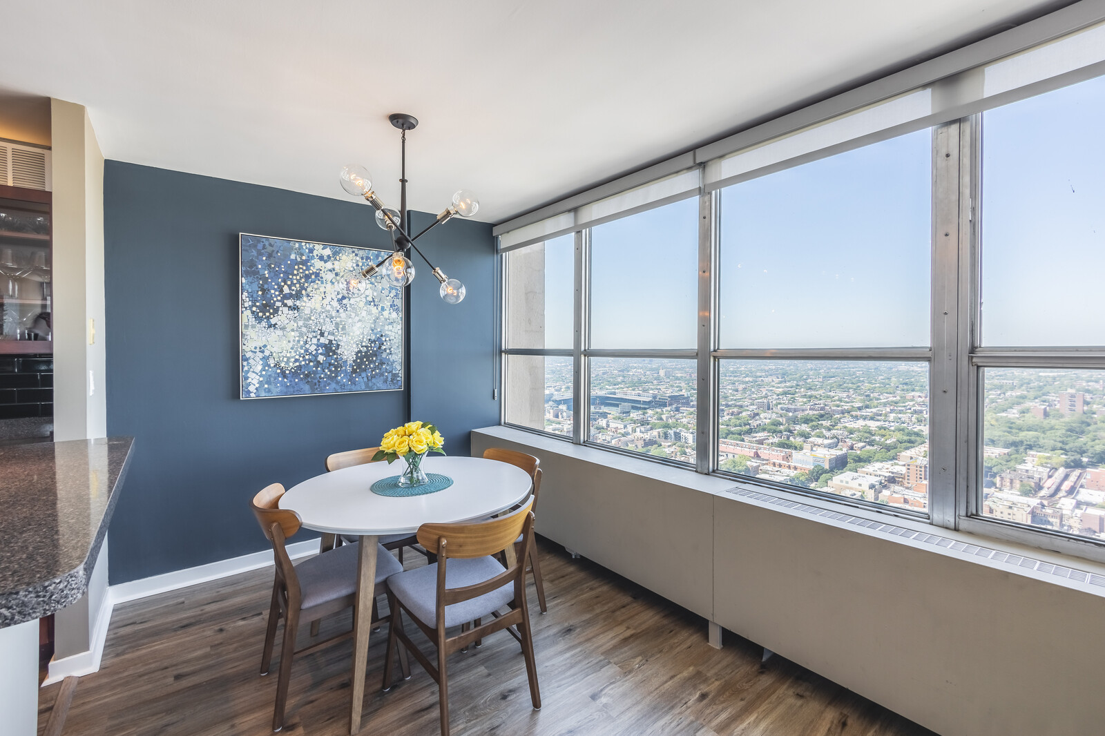 655 West Irving Park Road, Unit 4616 Chicago, IL 60613 - Photo 12 of 25 a dining room with furniture a window and a chandelier