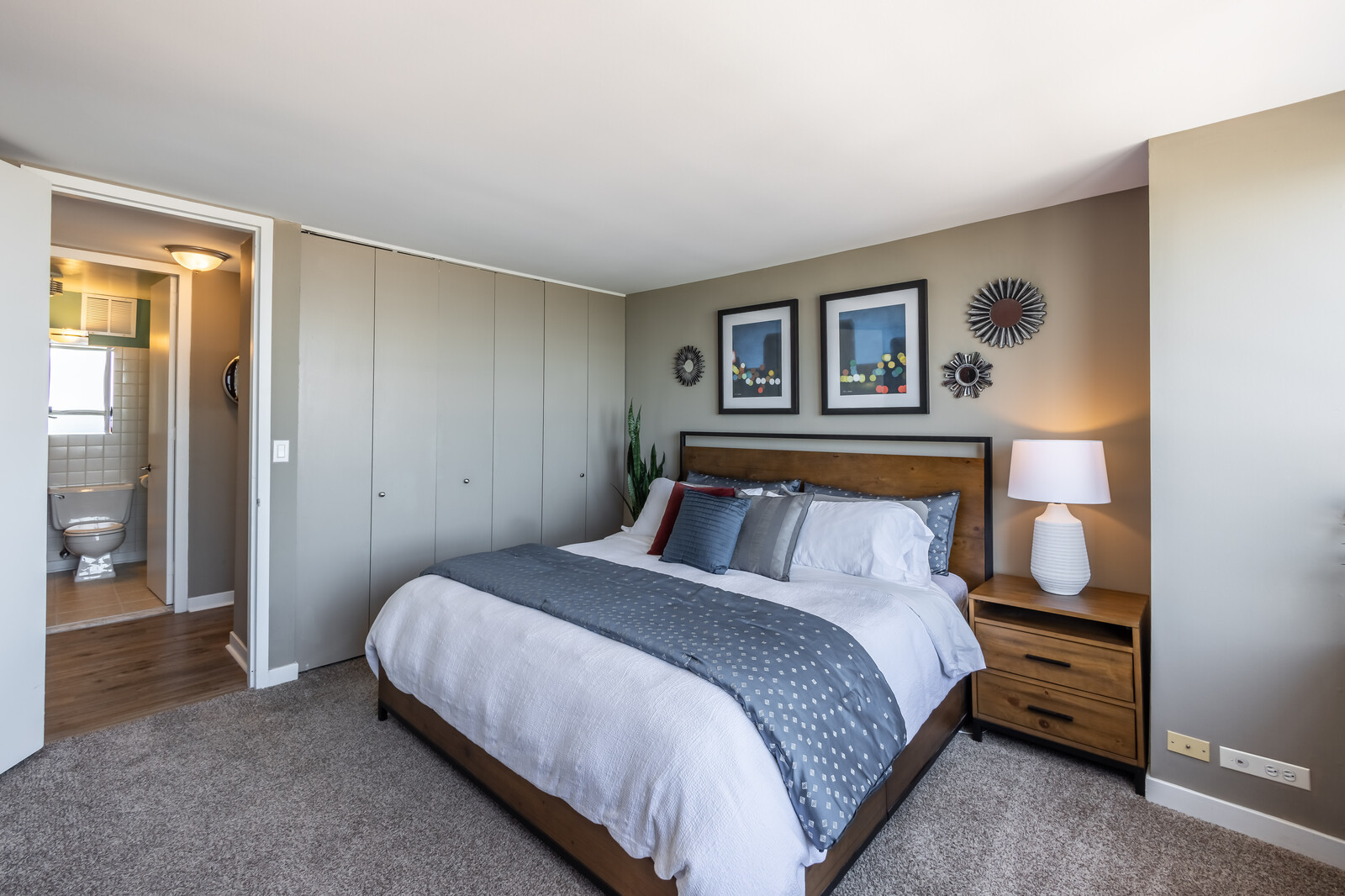 655 West Irving Park Road, Unit 4616 Chicago, IL 60613 - Photo 16 of 25 a bedroom with a bed and a painting on the wall