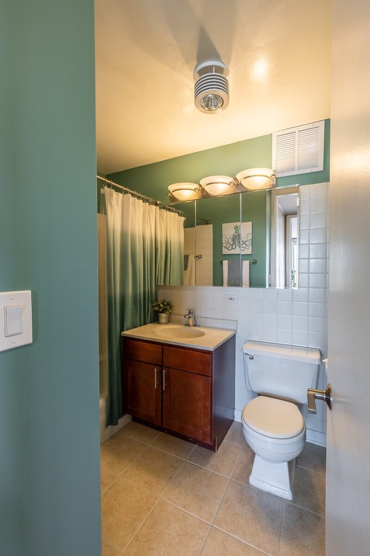 655 West Irving Park Road, Unit 4616 Chicago, IL 60613 - Photo 18 of 25 a bathroom with a toilet sink and mirror