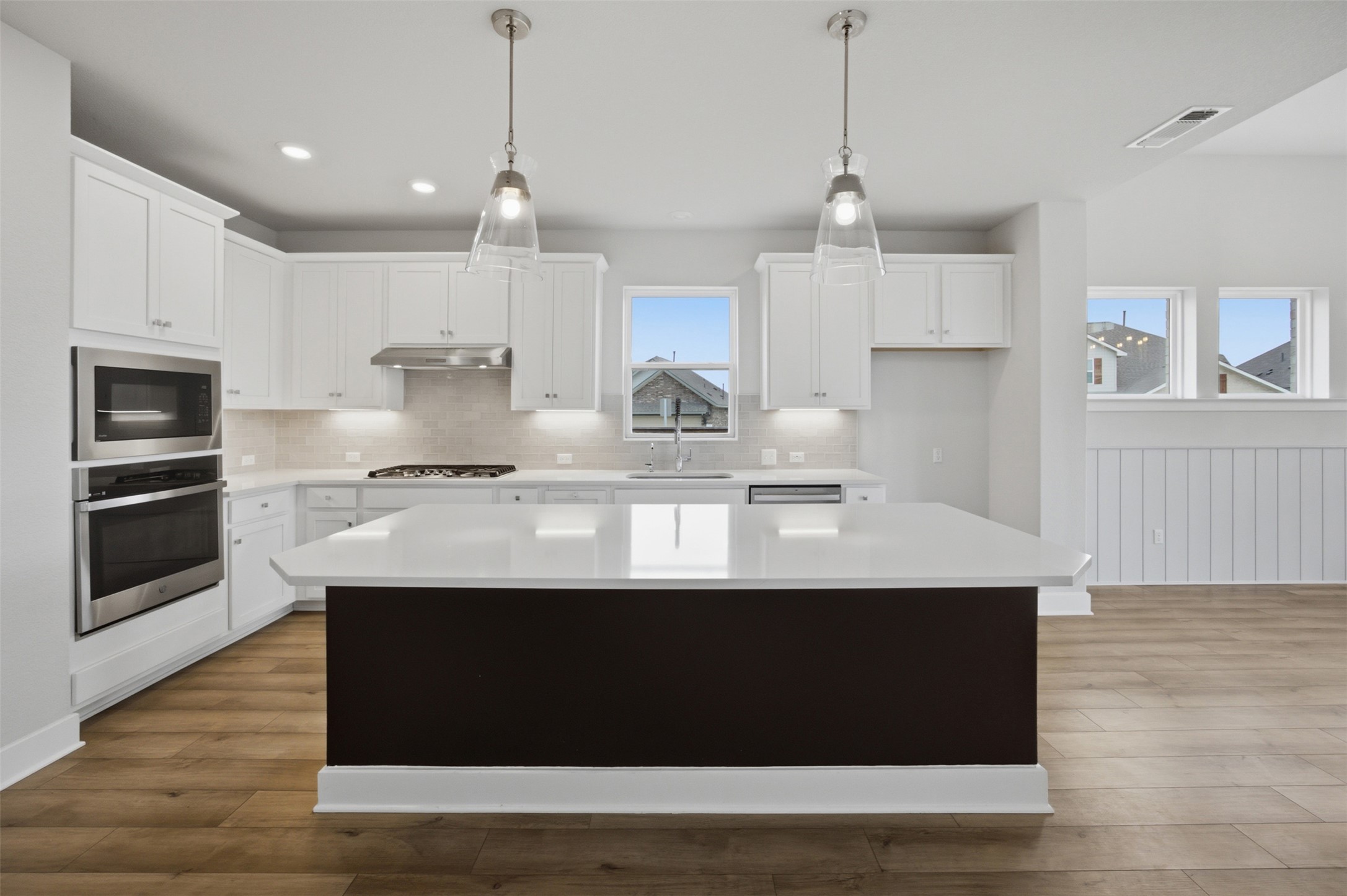 2101 Little Snake Way Georgetown, TX 78633 - Photo 12 of 37 Prepare meals in a kitchen featuring an expansive island, abundant cabinetry, and durable flooring.