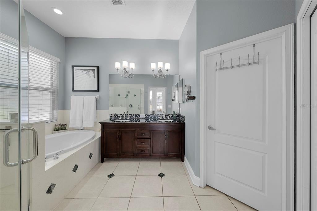 5210 Covesound Way Apollo Beach, FL 33572 - Photo 24 of 82 a large bathroom with a tub sink and mirror