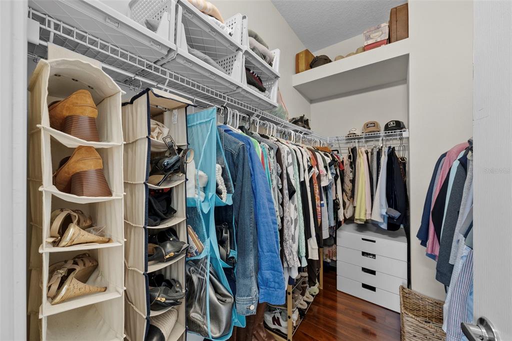 5210 Covesound Way Apollo Beach, FL 33572 - Photo 26 of 82 a view of walk in closet with clothes and shoes