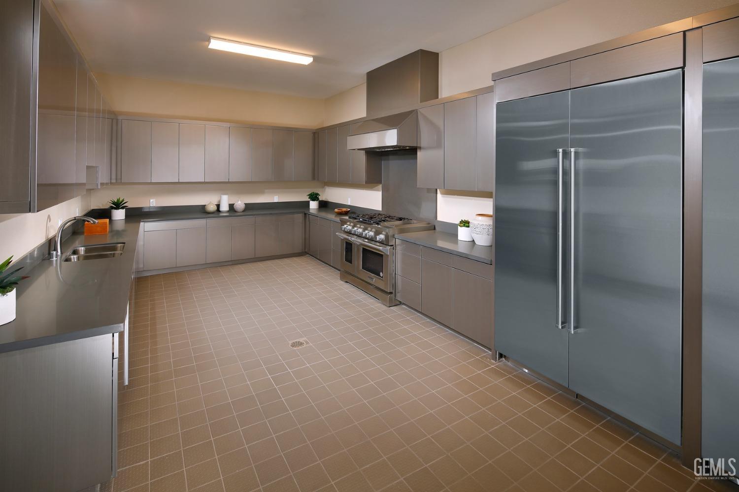 Undisclosed Address Bakersfield, CA 93311 - Photo 4 of 16 a large kitchen with cabinets and stainless steel appliances