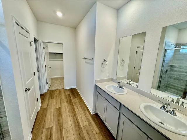 a spacious bathroom with a double vanity sink and a mirror