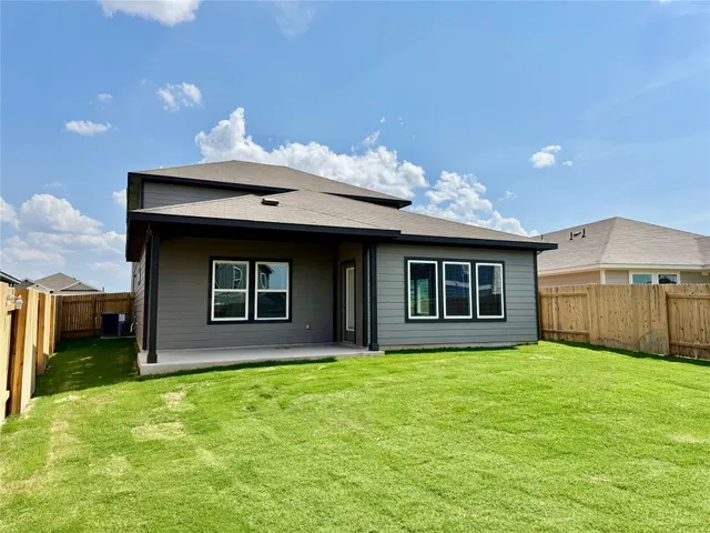 a front view of a house with yard and garage