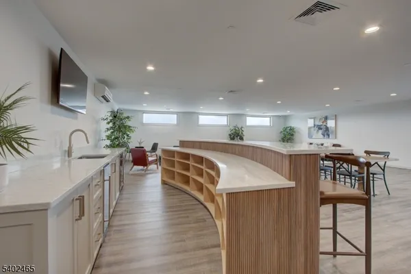 a kitchen with stainless steel appliances granite countertop a table chairs and a refrigerator