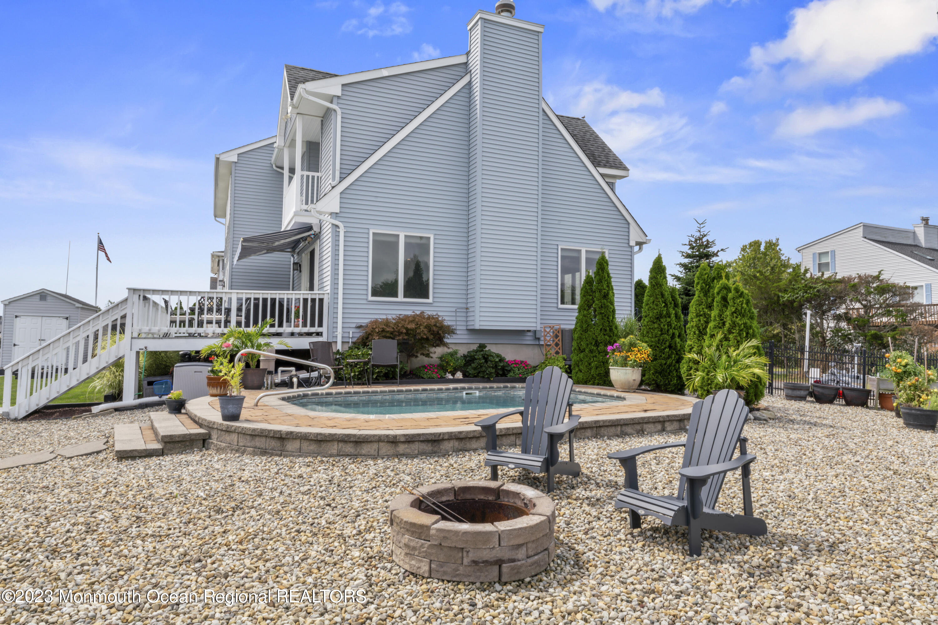 42 Capstan Road Waretown, NJ 08758 - Photo 38 of 57 a view of a patio with table and chairs potted plants and palm tree