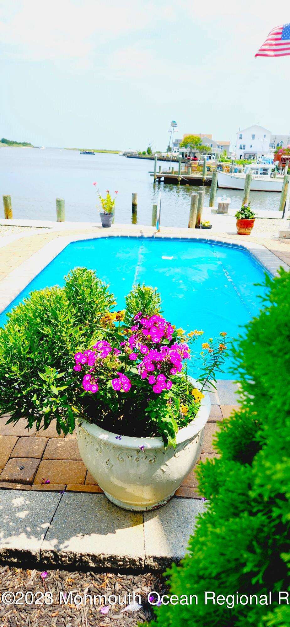 42 Capstan Road Waretown, NJ 08758 - Photo 54 of 57 a view of a swimming pool with an outdoor seating
