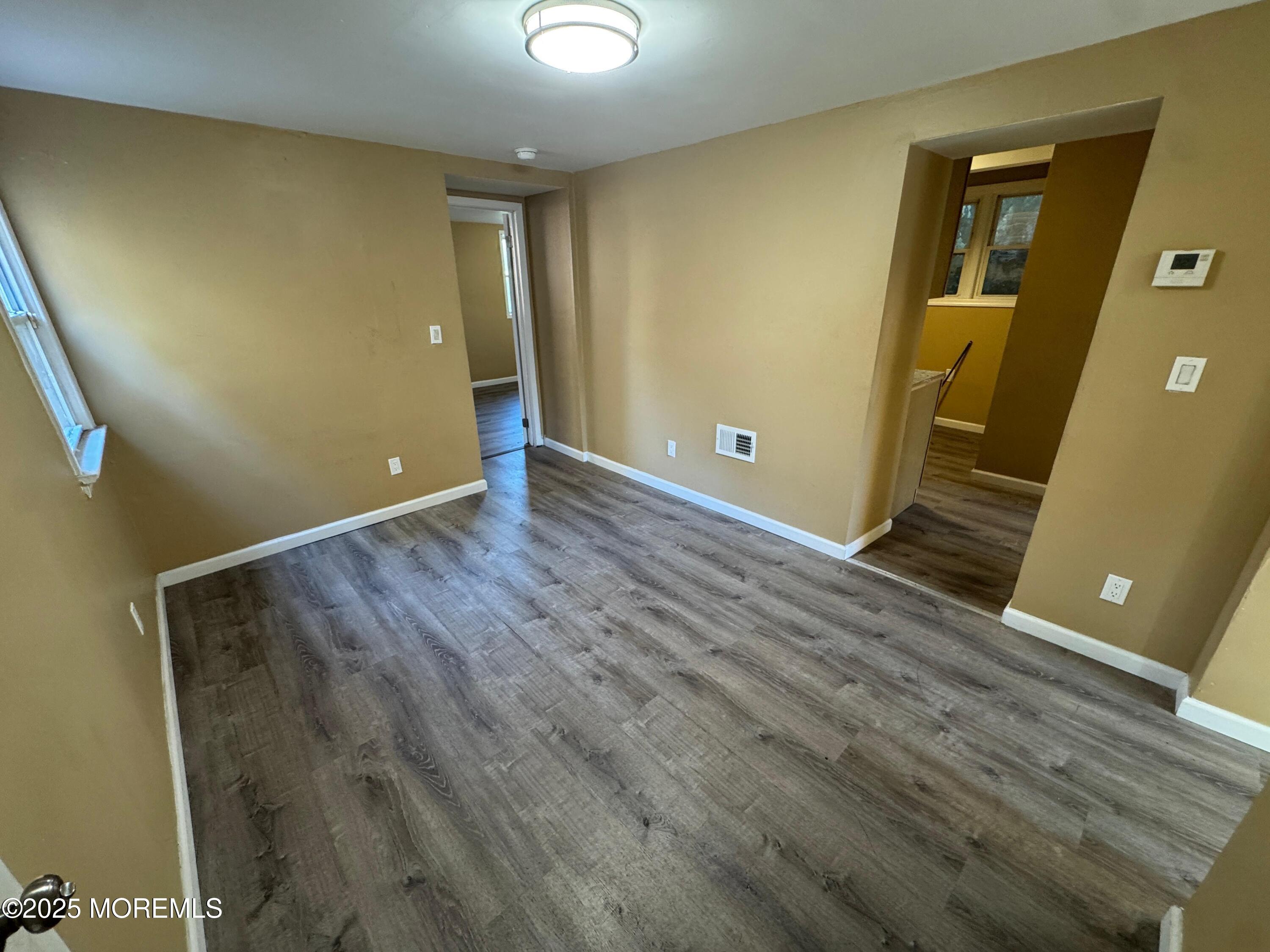 724 Cortlandt Street, Unit 5 Perth Amboy, NJ 08861 - Photo 1 of 10 a view of an empty room with wooden floor