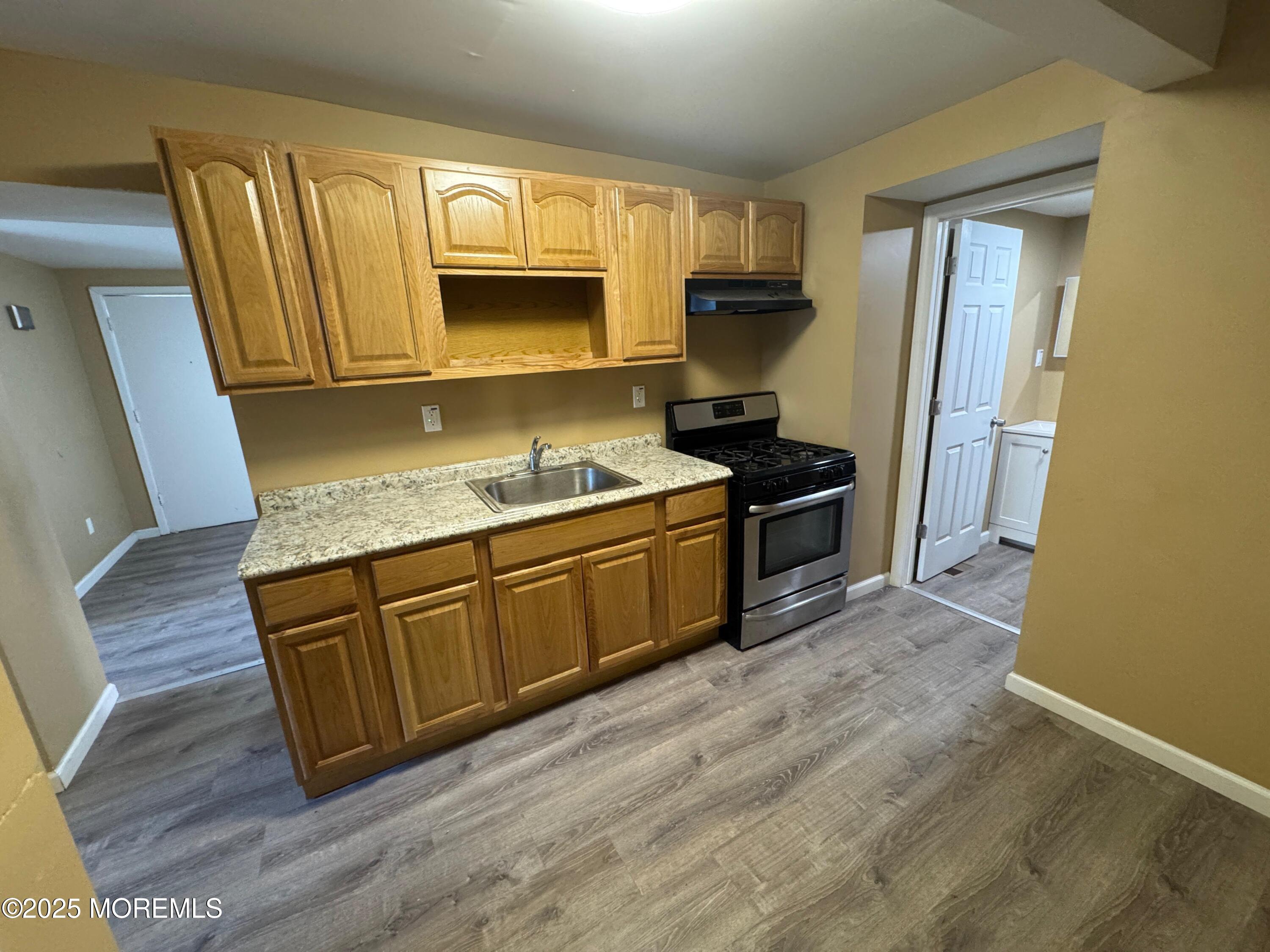 724 Cortlandt Street, Unit 5 Perth Amboy, NJ 08861 - Photo 5 of 10 a kitchen with stainless steel appliances granite countertop a sink stove and refrigerator