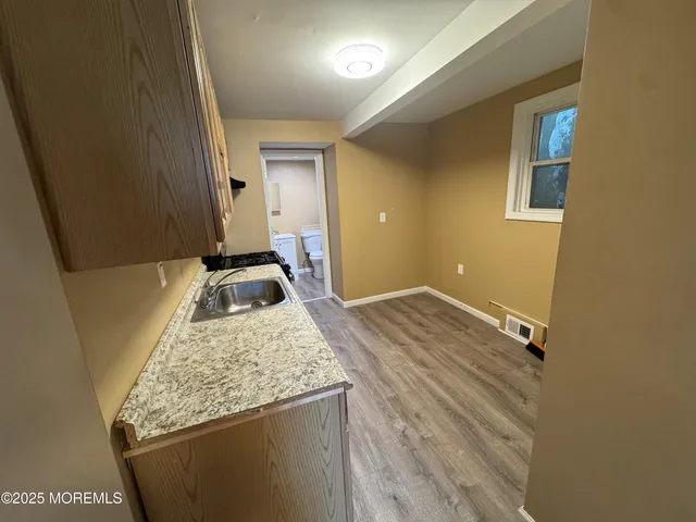 a bathroom with a granite countertop sink and a mirror