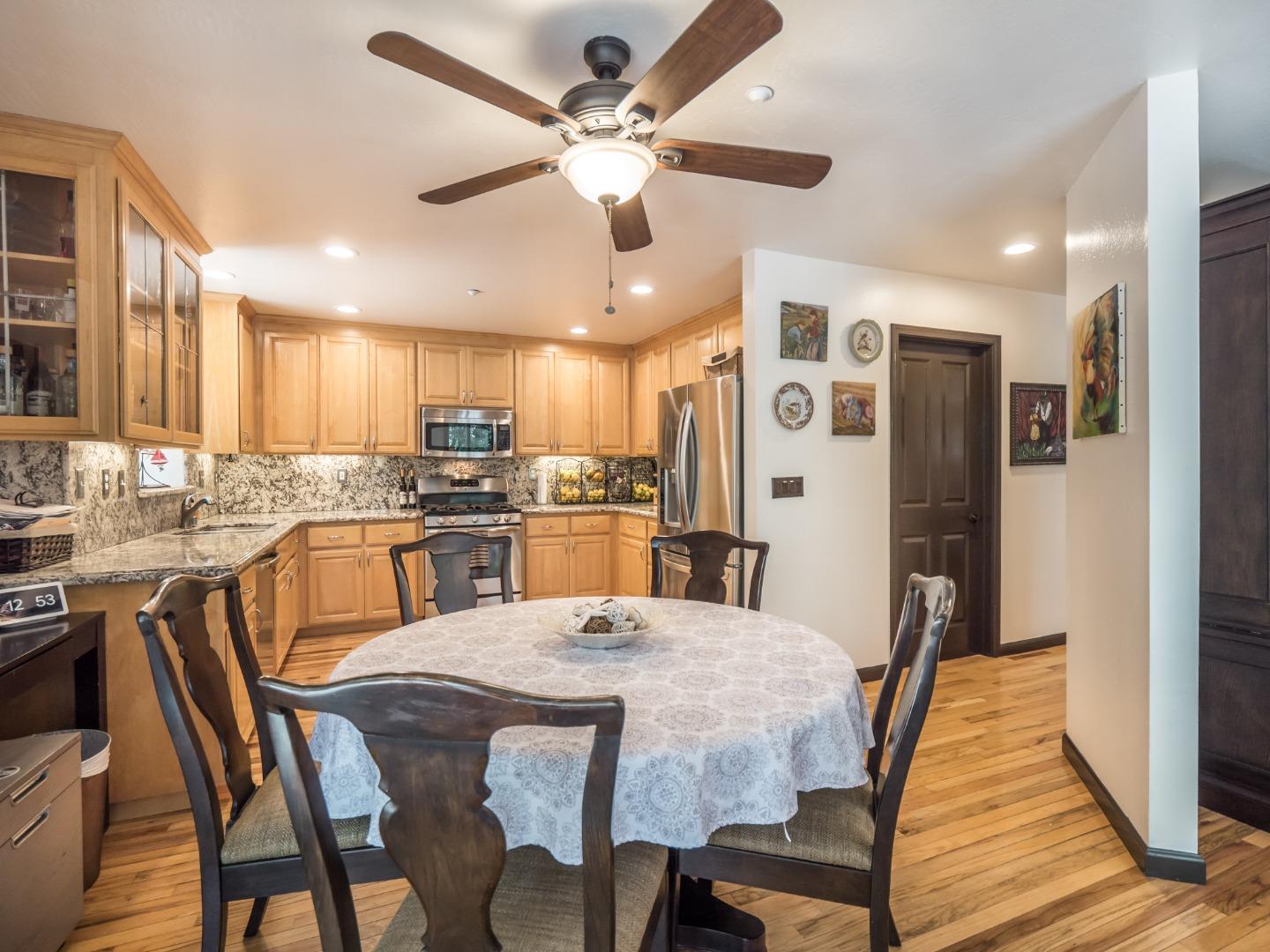 2185 Hames Road Aptos, CA 95003 - Photo 26 of 88 a kitchen with stainless steel appliances granite countertop a dining table chairs refrigerator and microwave