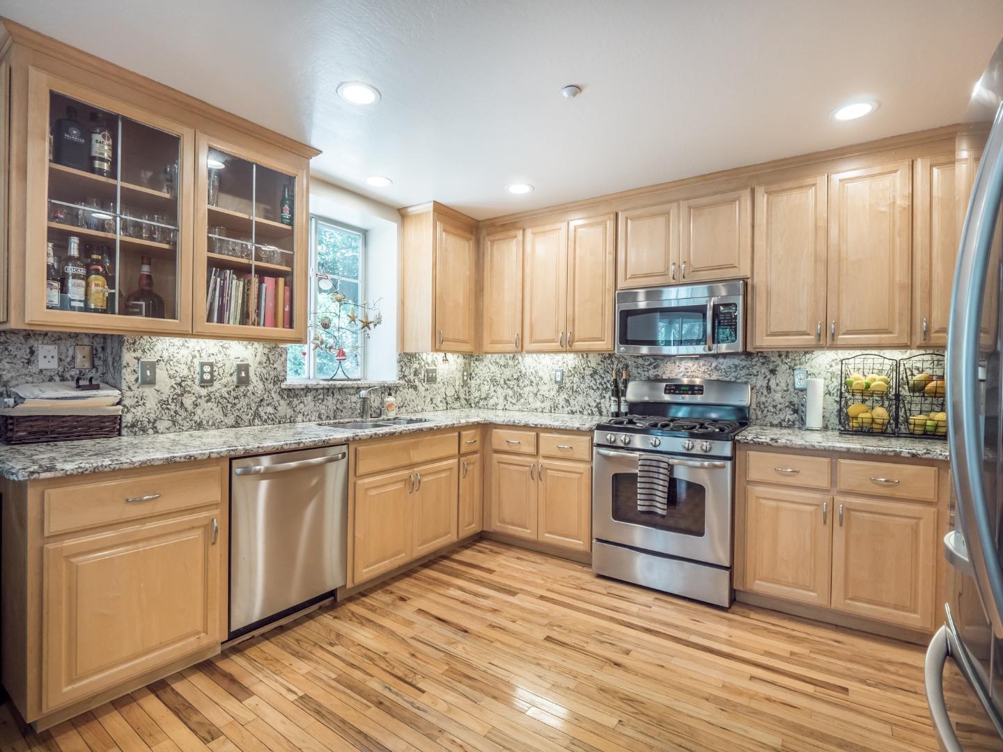 2185 Hames Road Aptos, CA 95003 - Photo 28 of 88 a kitchen with stainless steel appliances granite countertop a stove a sink dishwasher and a microwave oven with white cabinets