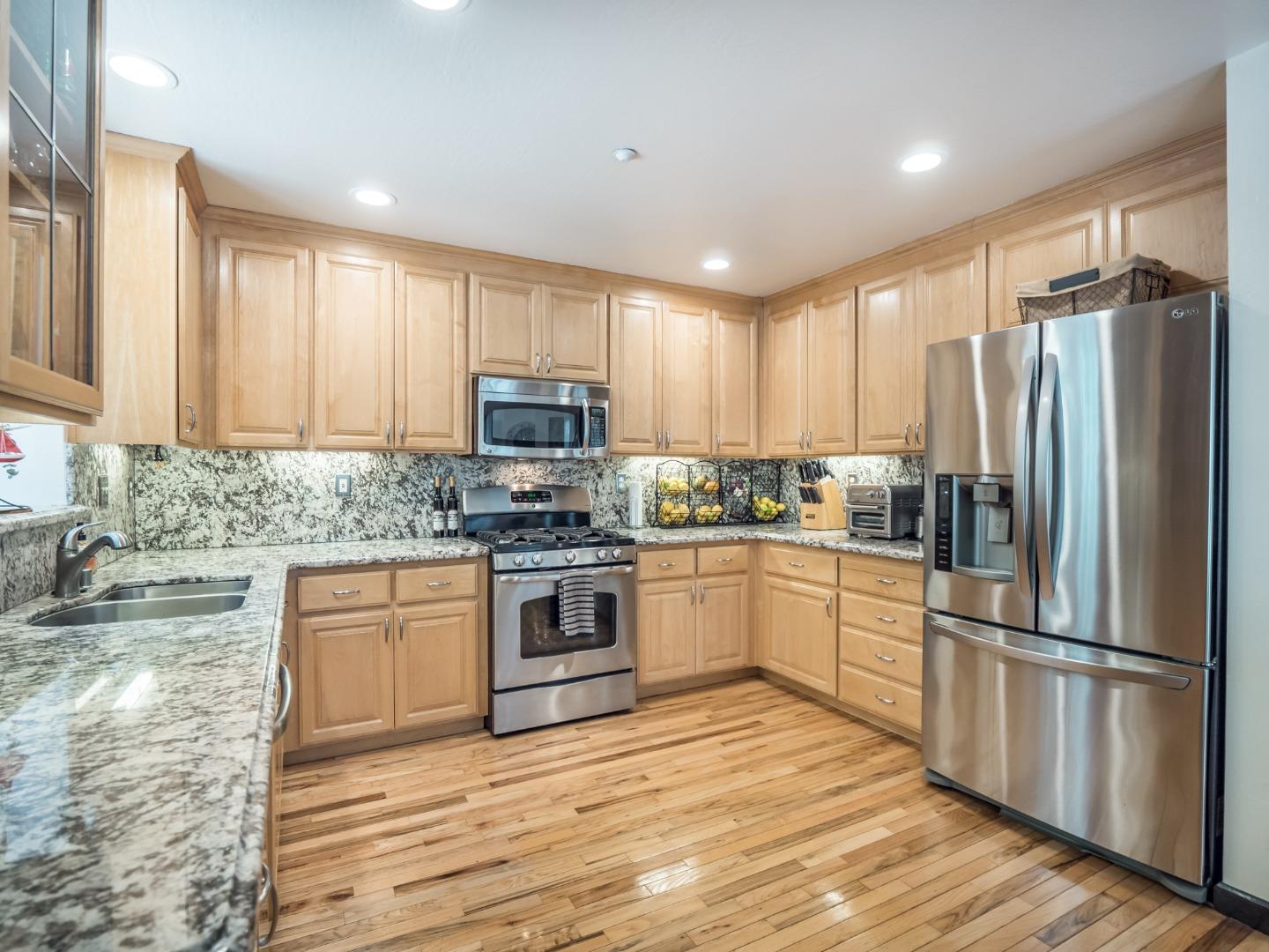 2185 Hames Road Aptos, CA 95003 - Photo 29 of 88 a kitchen with granite countertop white cabinets and stainless steel appliances