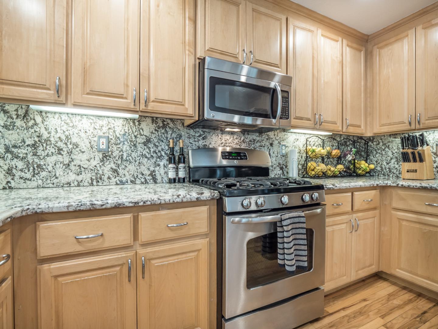 2185 Hames Road Aptos, CA 95003 - Photo 31 of 88 a kitchen with granite countertop white cabinets stainless steel appliances and a sink