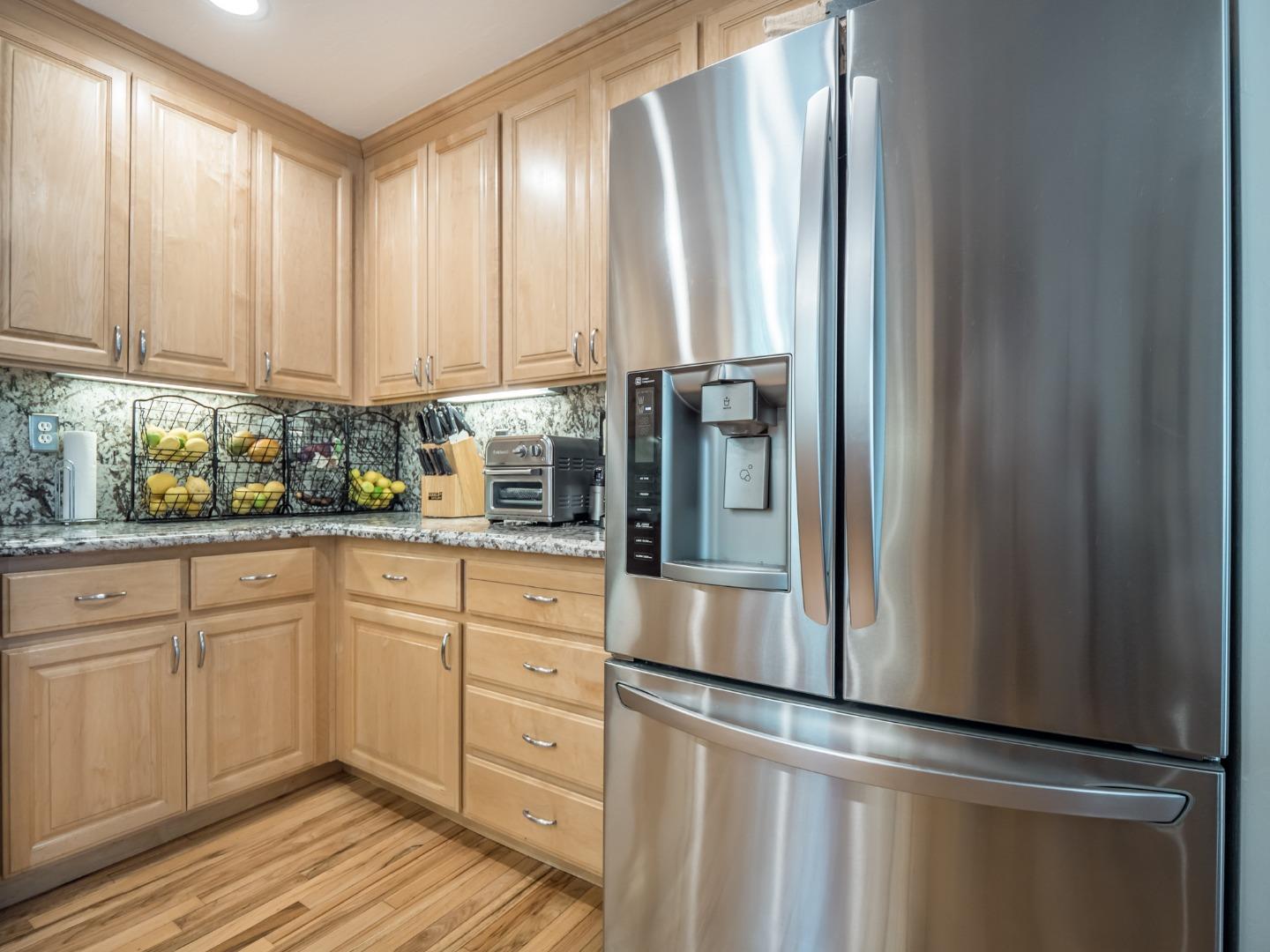 2185 Hames Road Aptos, CA 95003 - Photo 33 of 88 a kitchen with stainless steel appliances granite countertop a refrigerator and white cabinets