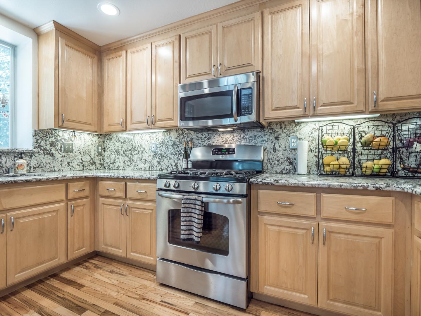 2185 Hames Road Aptos, CA 95003 - Photo 34 of 88 a kitchen with granite countertop white cabinets stainless steel appliances and sink