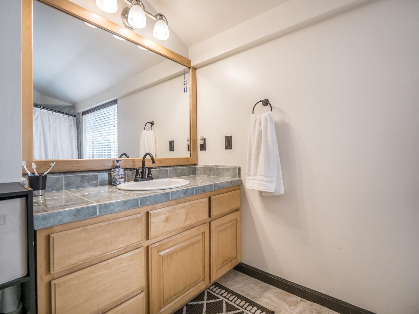 2185 Hames Road Aptos, CA 95003 - Photo 49 of 88 a bathroom with a sink and mirror