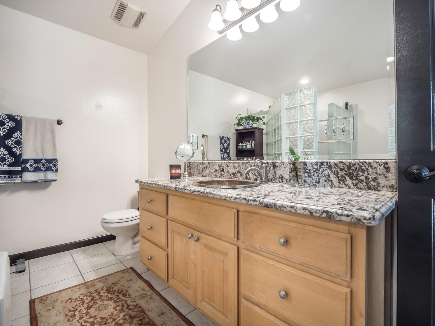 2185 Hames Road Aptos, CA 95003 - Photo 54 of 88 a bathroom with a granite countertop sink a toilet and a mirror